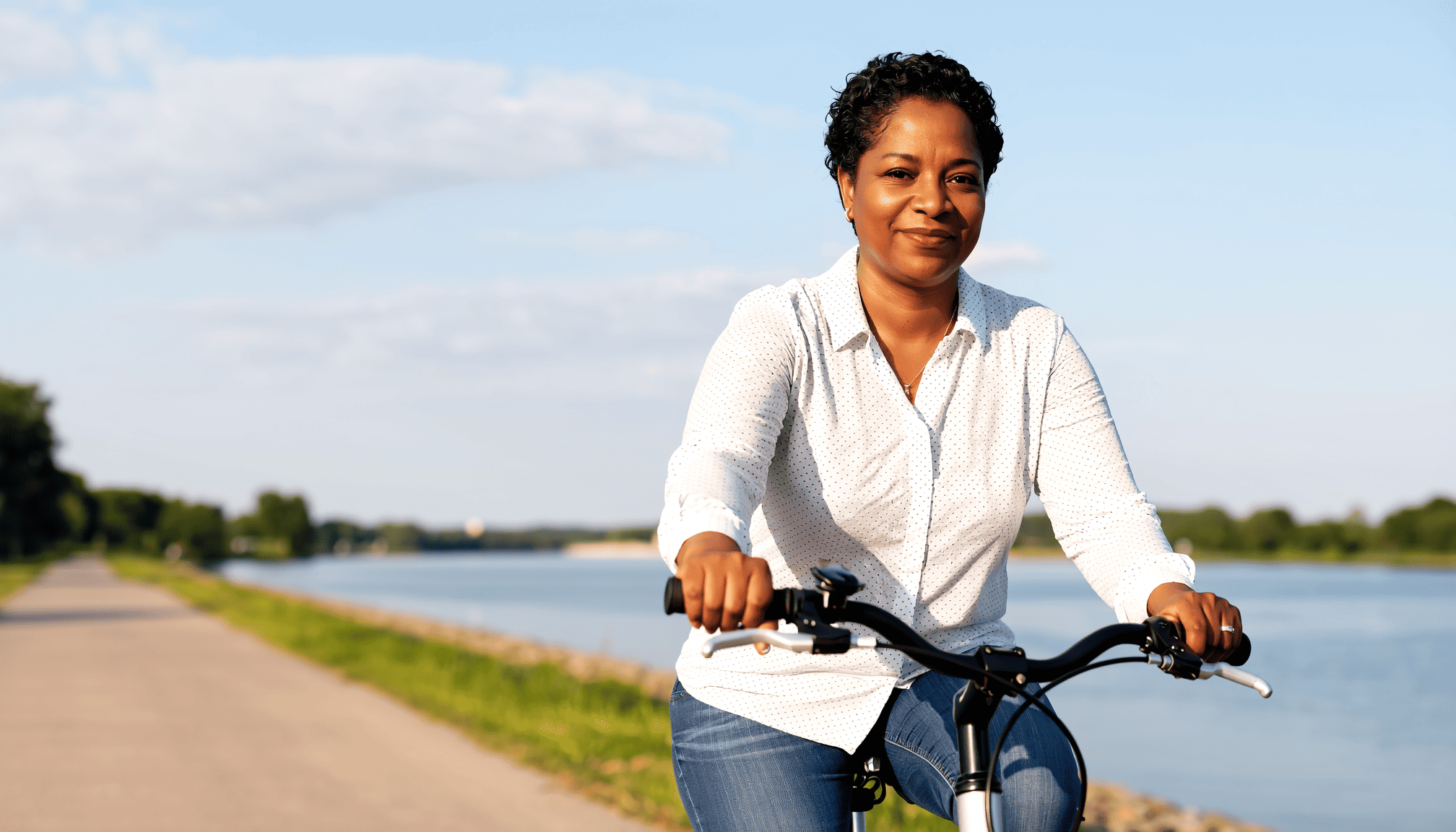 woman-riding-bike-along-canal